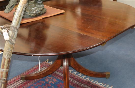 A George III style mahogany extending dining table W.167cm with leaf in